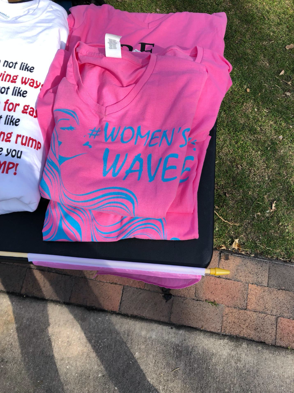 Figure 3. Image showing #womenswave appearing on merchandise (t-shirts) for sale at Lake Eola Park on Jan. 19, 2019.