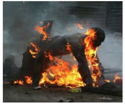 This image shows a man who has seemingly set himself on fire.