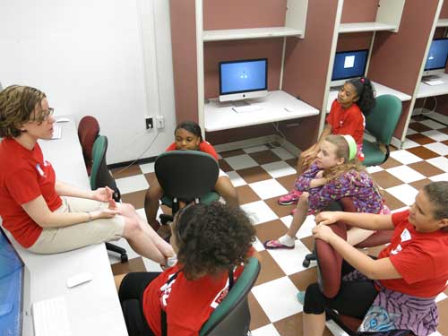 Rachel talks to a group of campers in a computer lab