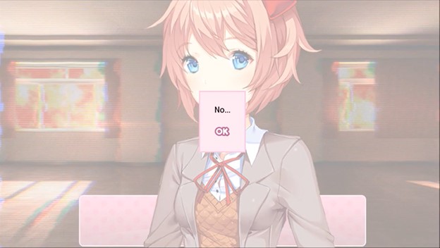 A screenshot of Sayori from DDLC. She is in front of the original dialogue box and the background is the same background in Just Monika room. A new dialogue box appears over her face. It just says 'No' and the players' only option is to click 'OK'.
