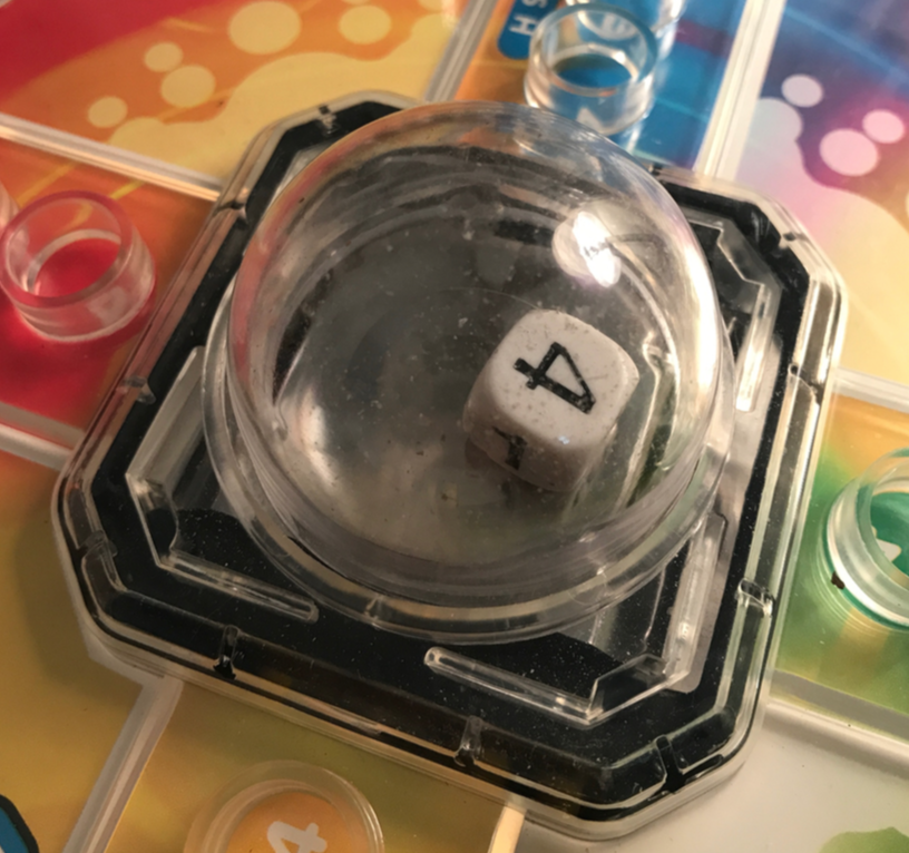 Up close view of the Trouble board game board and its plastic bubble with a die inside