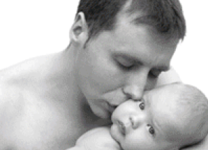 black and white picture of nude man snuggling a child