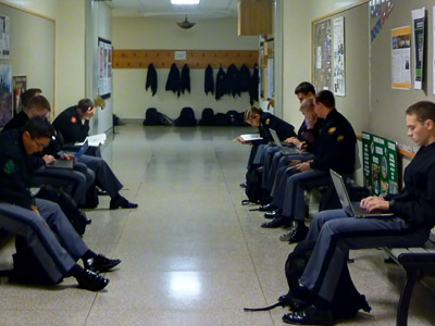 West Point cadets work studying in the hallways.