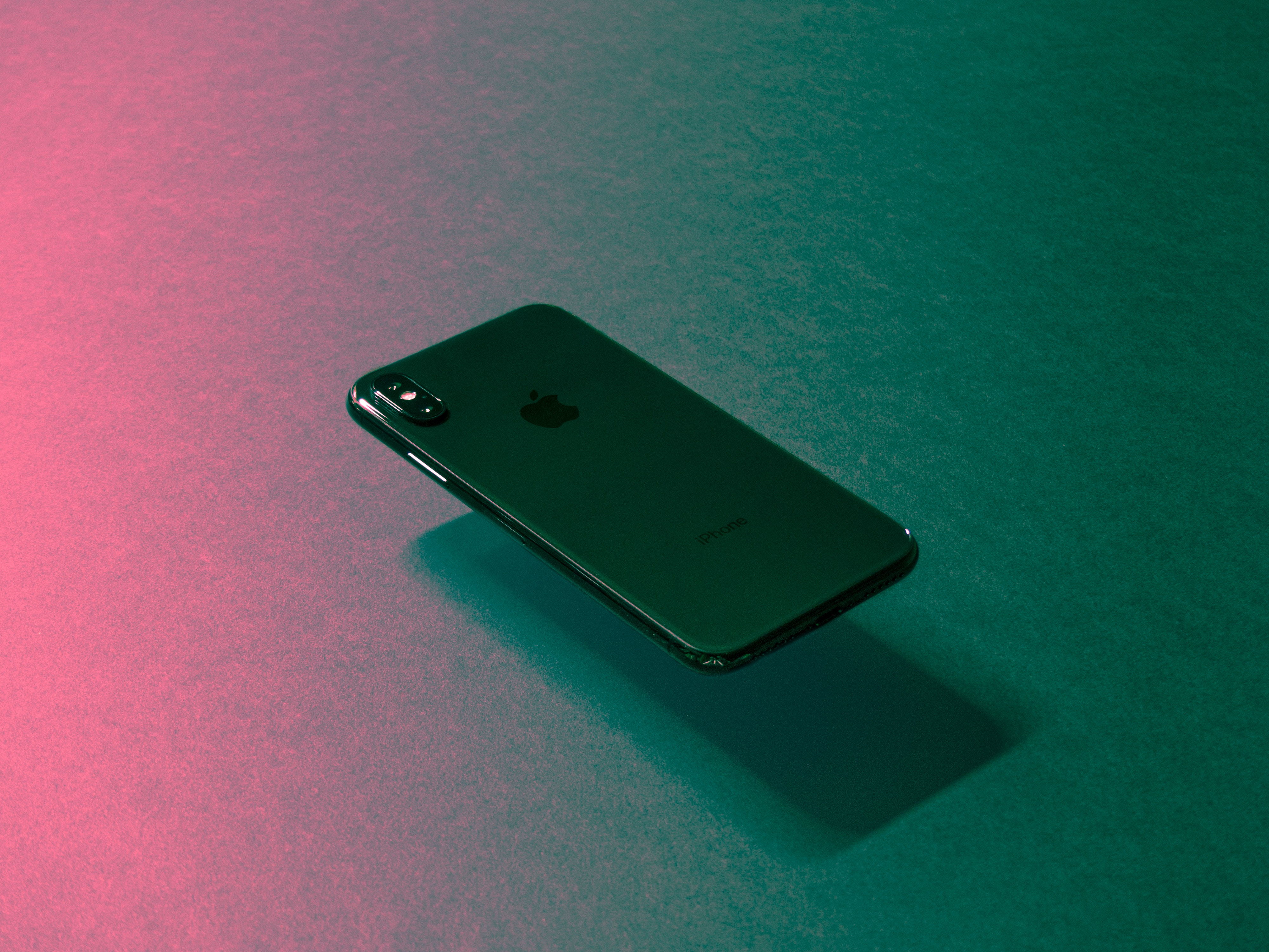 Image of a smartphone with a techno-colored background.